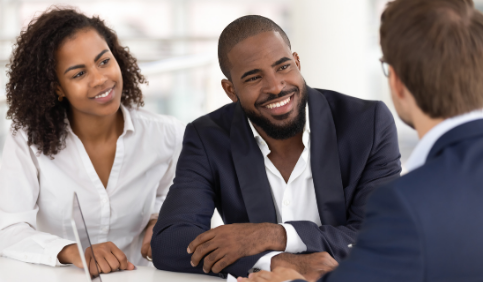 Happy African American couple consulting a REALTOR®